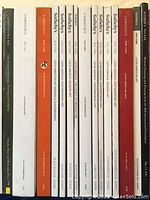 Photo showing 16 Latin American art auction catalogs displayed upright, titles visible on spines, mostly Sofia's and Christie's.