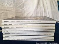 Spine view of Sotheby's watch auction catalogs showing titles, locations, and dates from 2015 to 2018.