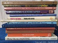 Photo of 12 painting instructional books stacked horizontally