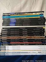 Complete view of stacked Sotheby’s and Ritchies auction sale catalogs focusing on Important Canadian Art.