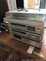 Front view of Yamaha stereo system stack including turntable on top and amplifier, tuner, cassette deck below