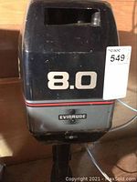 Front view of motor top cowling with “8.0” decal and lot tag