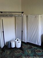 Photo showing clothing rack, collapsible closets, two small bins