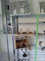 Metal horn-shaped bottle openers, metal antler jewelry holder, faux antler card holders, wooden box on metal shelving.