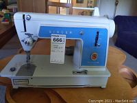Front and side view of Singer Touch and Sew 604R sewing machine highlighting the blue faceplate and machine features.