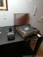 Full view of the turntable with dust cover, iPod and iHome docking station on black table