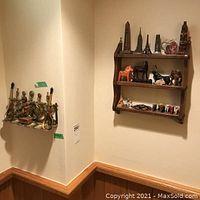 Full view of wooden wall shelf mounted on the wall with various figurines and decorative items.
