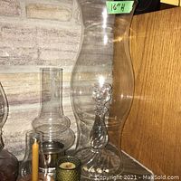 Oil lamp, candle holder, green votive candle holder, and glass chimneys.