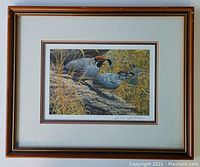Framed print with wooden frame and double matting shown hanging.