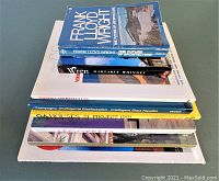 Stack of 8 architectural books viewed from above showing titles including Frank Lloyd Wright and Christopher Wren.
