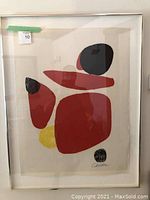Framed abstract print showing colored shapes and signature