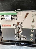 Retail packaging for La Pavoni espresso machine showing model image and branding