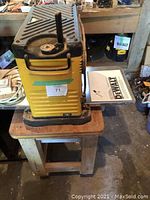Top view of the DeWalt planer on stand showing overall condition and included stand