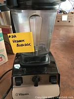 Vitamix blender base with control dial and clear plastic pitcher attached