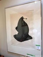 Full view of framed print showing abstract black silhouette on off-white background