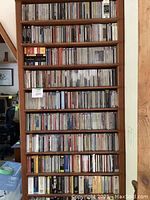 Full wooden shelving unit filled with CDs