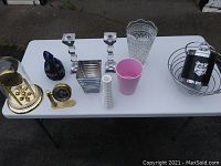 Photo of lot on white table with items displayed in a row