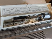 Complete view of Singer Knitting Machine Model 700 with needle beds and knitting tools in storage compartment