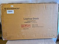 Cardboard box with SONGMICS branding and product details including item number LLD01N and dimensions.