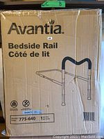Original boxed Avantia adjustable bedside rail with grab bar, showing packaging with product illustration and labeling.