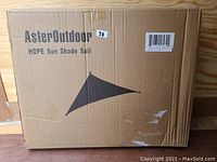 Cardboard box of Asteroutdoor HDPE Sun Shade Sail Triangle 10'x10'x10' showing brand name, product image and labeling.