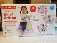 Box of Skip Hop 3-in-1 ride on toy showing the front packaging with image of child riding the unicorn themed toy and highlighting features like stages of use and sounds.