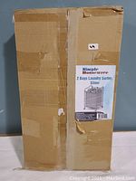Cardboard packaging box for SimpleHouseware 2 Bags Laundry Sorter, silver color, heavy duty rolling laundry sorter cart.