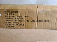 Box showing product details: white picture ledge shelf, size 35.4 x 4.5 x 3.5 inches, item number 9084678, made in China.