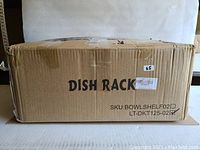 Cardboard box labeled 'DISH RACK' and SKU information, sealed, indicating new condition for the dish rack.