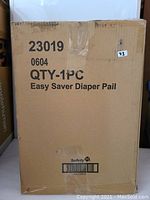 Photo showing the sealed cardboard box of Safety 1st Easy Saver Diaper Pail with printed label and quantity (1 PC).
