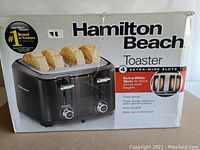 Photo of the original carton box showing Hamilton Beach branding, toaster image and features.