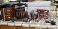 Overview of ice cream maker barrel, wine press, ice bucket, liquor measuring cup, corkscrew, wine glasses, and coasters.