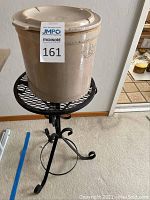 Overall view of the 2 gallon crock pot sitting on the black iron plant stand.