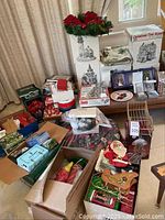 Overview of multiple boxes and tabletop covered with assorted holiday decorations