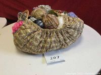 Knitting bag filled with assorted yarns visible