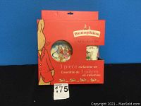 Front view of the packaging showing the red box with Bunnykins logo and a circular cutout displaying the melamine plate illustration.