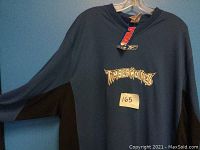 Blue long-sleeve Timberwolves shirt with NBA and Reebok tags visible, size XL indicated.