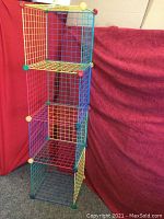 Full view of the colorful wire cube storage organizer shelving unit showing five stacked cubes and primary color wiring and corner pieces.