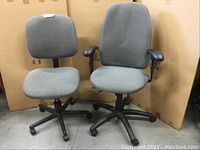 Front view of two office chairs side by side, showing their design and fabric upholstery.