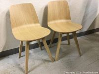 Front view of two chairs showing seat and leg design