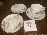 Photo showing two floral Haviland Sylvia saucers with pink and lavender flowers and gold trim.
