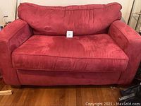 Front view of red twin size sleep sofa showing cushions and armrests