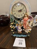 Full view of the Turtle King Corp decorative clock featuring an angel and two children figurine base and round clock face.