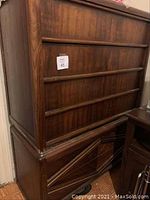 Side view of 6 drawer upright bureau showing wood grain and drawer design