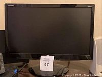 Photo of Compaq computer monitor with black frame and stand