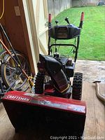Front view of Craftsman snowblower showing control panel, two handles, and chute.