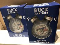 Two unopened Buck Martinez alarm clocks in blue packaging with Toronto Blue Jays logos, front view.