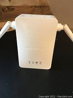 Front view of Netgear WN3000RP WiFi range extender showing brand name and LED indicator lights.