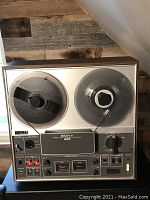 Front view of Sony TC-366 reel to reel tape recorder showing dual reels loaded with tape, control panel with multiple knobs, switches, and meters.