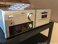 Victor XU-NXMD3 compact MD system powered on, lights active, with blank MiniDiscs on top